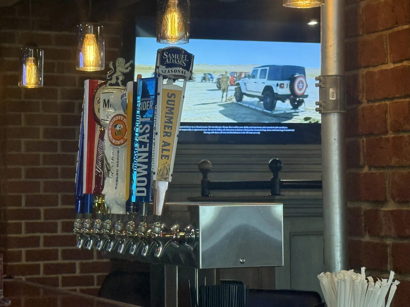 The draft tower at the bar: Sam Adams Summer Ale, Downeast Cider, Thirsty Dog and Yuengling tap handles